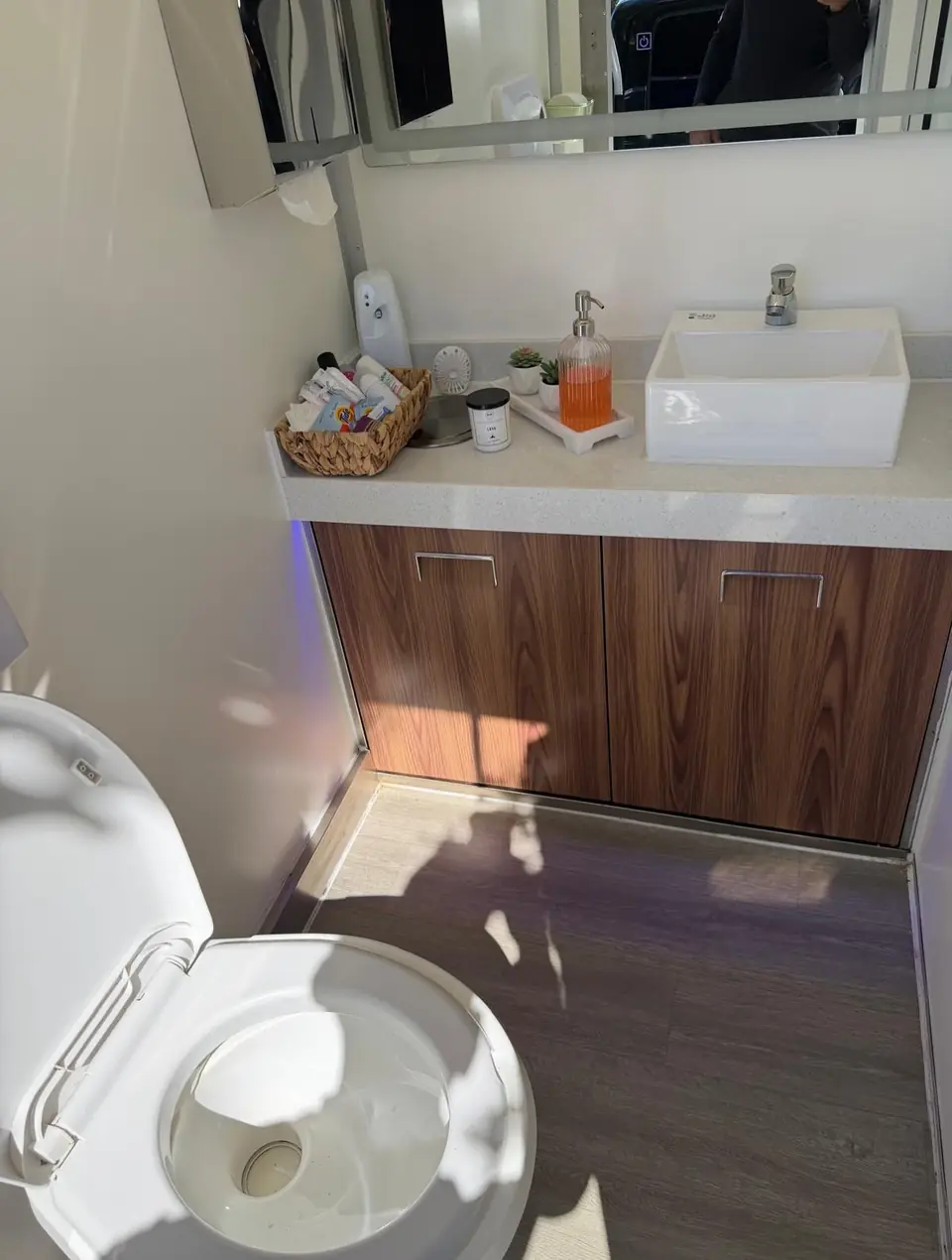 Restroom trailer vanity with vessel sink, soap and an amenity basket